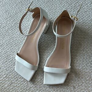 Stuart Weitzman white sandals.